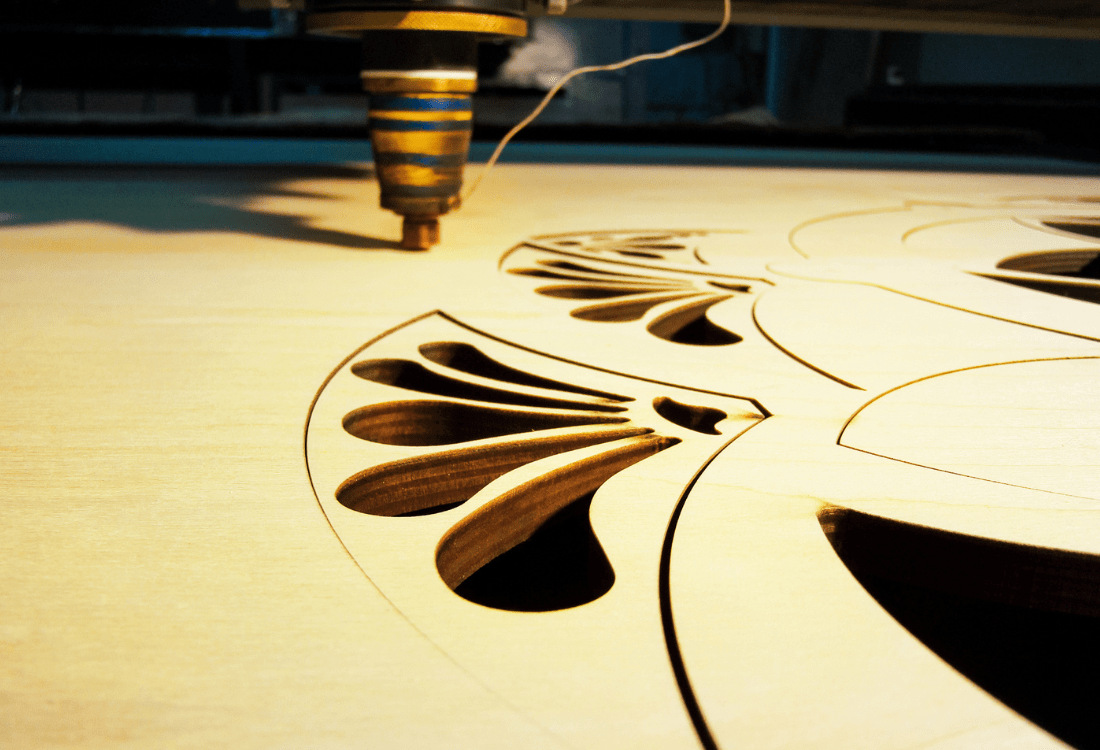 An image of wood being cut with a laser cutter with factors being considered for the first time. 