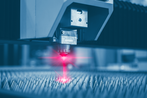 A laser cutter being used in a high end production factory to ensure an efficient scale of mass production. 