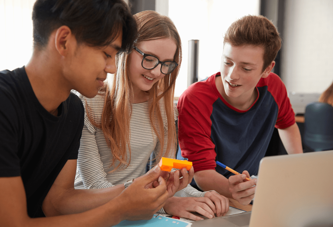 Students using acrylic for a school project due to its benefits.  